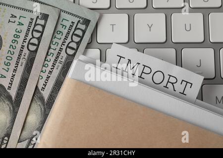 Note with word Import in documentation and dollar banknotes on computer keyboard, top view Stock Photo