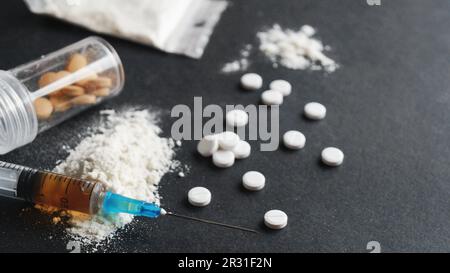 Different hard drugs on black background, closeup Stock Photo