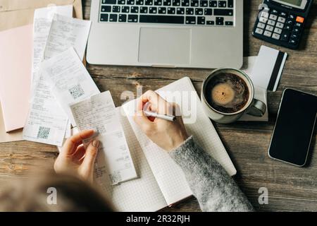A female accountant considers the family budget and expenses. Stock Photo
