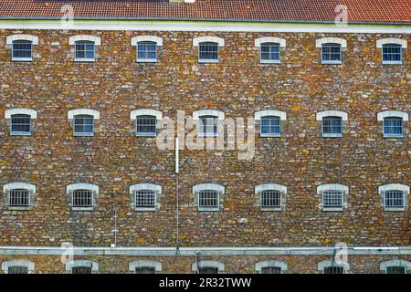 Cell windows aligned on the stone wall of the former prison of the city center of Meaux in the French department of Seine et Marne near Paris Stock Photo