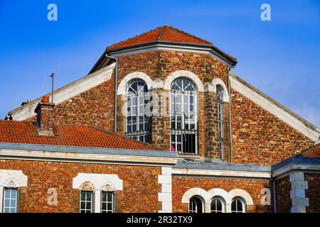 Former prison of the city center of Meaux in the French department of Seine et Marne near Paris - Old stone jail with barred windows and a large nave Stock Photo
