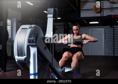 Hardcore sport. Handsome young focused male athlete with toned strong  muscular body doing leg raise pull ups at the gym determination  concentration fitness sports power lifestyle concept copyspace Stock Photo
