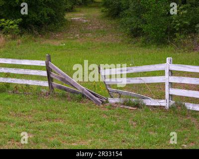 'Abandoned piece of broken white fence in rural North Florida. Stock Photo