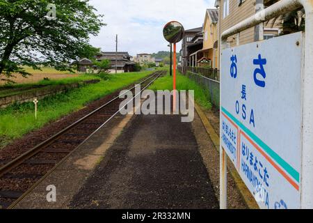 Hyogo, Japan - May 15, 2023: Empty platform by tracks at Osa Station next to houses in countryside Stock Photo