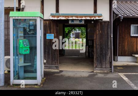 Hyogo, Japan - May 15, 2023: Phone booth by entrance to Osa Station, a historic wooden station in countryside Stock Photo