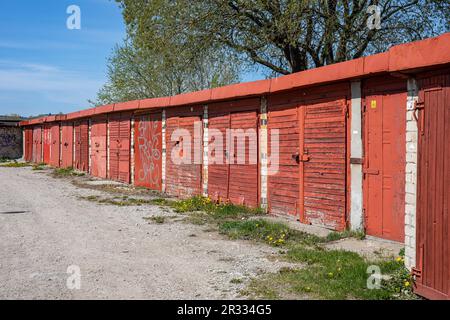 Line of old garages with red doors in Kalamaja district of Tallinn, Estonia Stock Photo