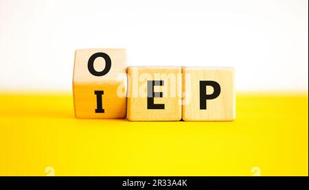 IEP or OEP symbol. Concept words IEP initial enrollment period OEP open enrollment period. Beautiful yellow table white background. Medical initial or Stock Photo
