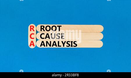 RCA root cause analysis symbol. Concept words RCA root cause analysis on wooden sticks. Beautiful blue table blue background. Business and RCA root ca Stock Photo