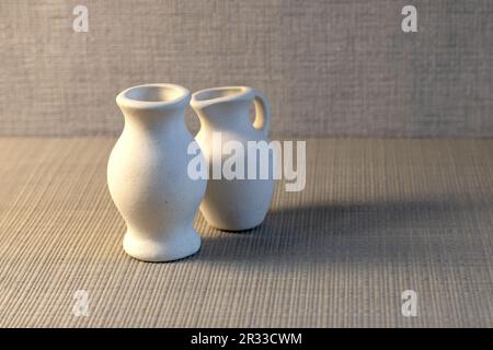 Handmade clay vase with small decor isolated on white background close up Stock Photo