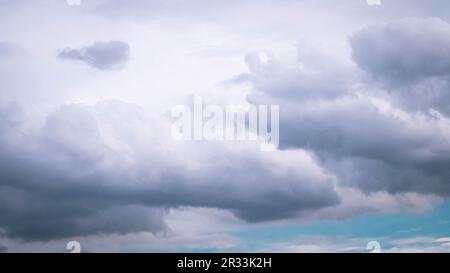 A dramatic full-frame view of thick, dark grey rain clouds and cumulus formations gathering before a heavy thunderstorm or monsoon Stock Photo