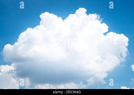 Large singleCumulonimbus clouds. cumulus cloud. Puffy or cotton like or fluffy cloud blue sky white fluffy clouds over blue sky landscape. Stock Photo