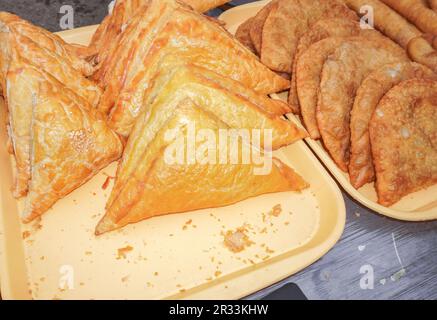 Georgian pastry. Puff pastry khachapuri. Khachapuri with chicken meat and cheese. Fried fresh khachapuri is a delicious street food Stock Photo