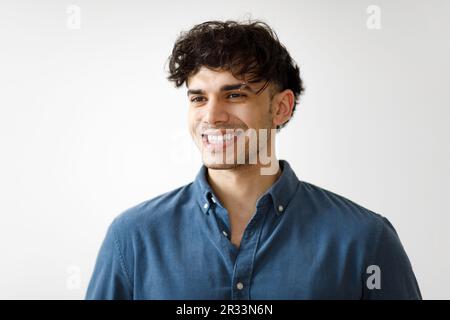 Portrait Of Handsome Arabic Young Man Posing Against White Wall Stock Photo