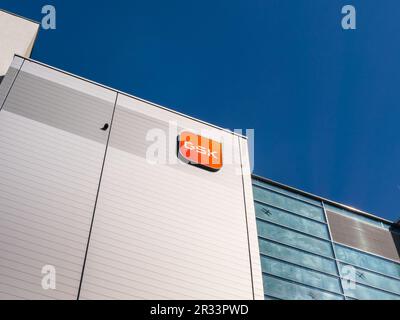 GSK logo sign of the multinational pharmaceutical company on a production hall. Big player in the health care industry and popular employer in Saxony. Stock Photo