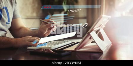 Man using tablet to chat with artificial intelligence robotic application GPT Chat Stock Photo