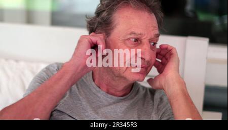 Pensive older man. Contemplative senior person frowning, thinking about decision Stock Photo