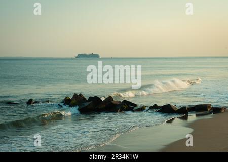 Waves crashing on rocks at the beach, Coney Island, Brooklyn, New York Stock Photo