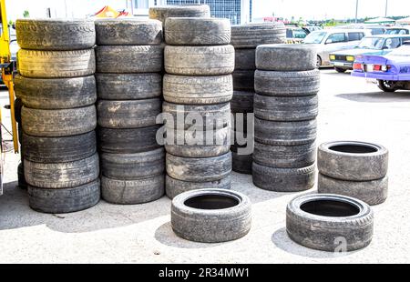 Samara, Russia - May 14, 2023: Used tires after drift stacked up on parking lot Stock Photo