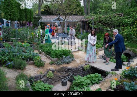 Chelsea, London, UK. 22nd May, 2023. The Savills Garden designed by Mark Gregory at the RHS Chelsea Flower Show. The garden evokes the experience of an intimate walled garden of an imagined country hotel, featuring a contemporary seasonal potager that offers both a sanctuary and a source of the very best in flavours. Credit: Maureen McLean/Alamy Live News Stock Photo