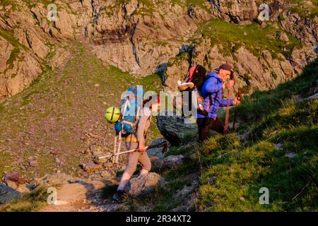 trekkers in the morning, Gentau lake, Ayous lakes tour, Pyrenees National Park, Pyrenees Atlantiques, France. Stock Photo