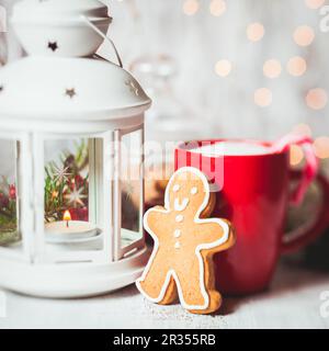 Wooden candlestick, gingerbread with Christmas tree branches and bokeh ...