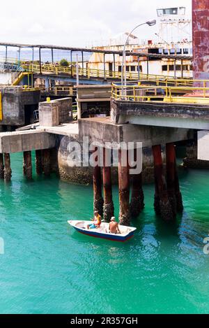 Vera Cruz, Bahia, Brazil - April 11, 2023: Small fishing boat with two men is seen at the maritime terminal on the island of Itaparica in Vera Cruz, B Stock Photo