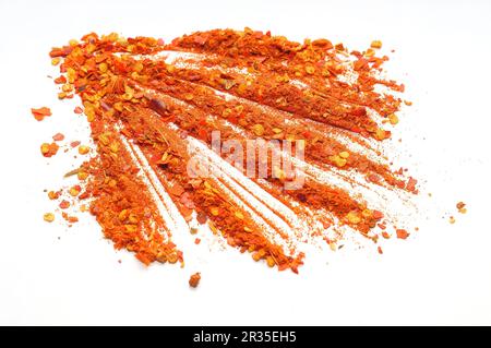 Red hot chili ground pepper scattered on a white background Stock Photo