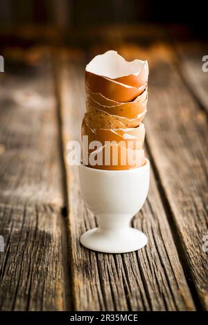 A stack of empty egg shells in an egg cup Stock Photo