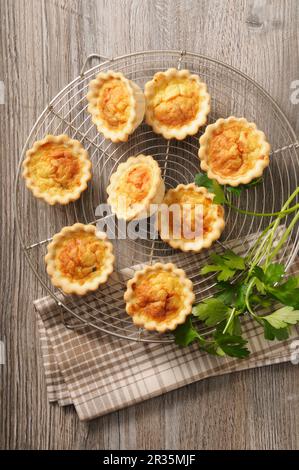 Spicy mini quiche on a cooling rack Stock Photo