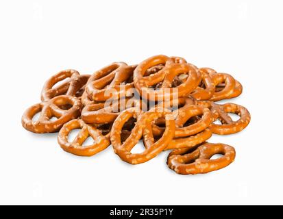 A pile of mini salted pretzels on a white surface Stock Photo