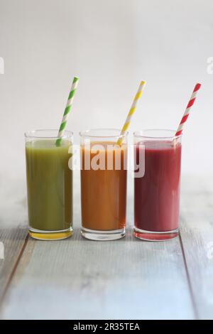 Three fruit and vegetable smoothies in different colours Stock Photo
