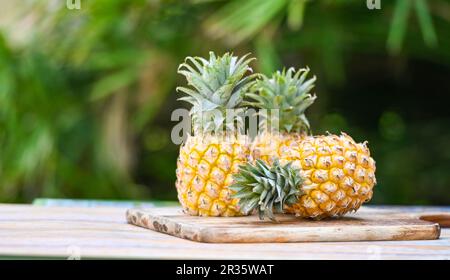 pineapple wooden cutting board for food fruit ripe pineapple on nature background, fresh pineapple tropical fruits summer Stock Photo