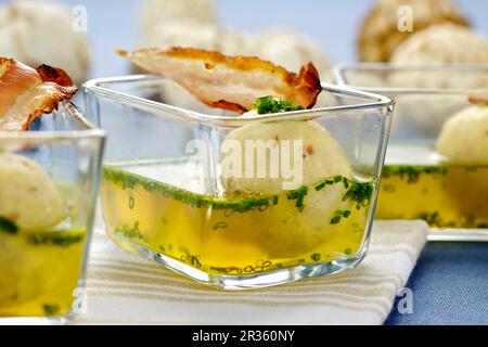 Soup with bacon and semolina dumplings in small glass bowls Stock Photo