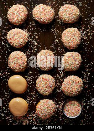 Caramel doughnuts with colourful sugar sprinkles Stock Photo