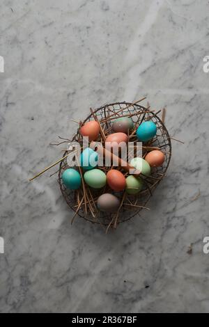 Easter eggs in a wire basket Stock Photo