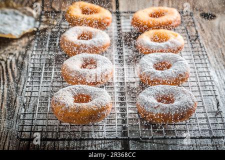 Freshly baked doughnuts dusted with icing sugar Stock Photo