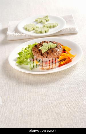 A veal burger on toast with herb butter Stock Photo