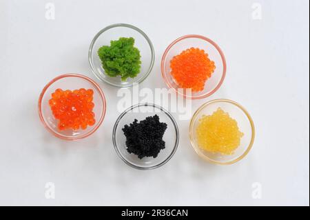 Various types of caviar in glass bowls Stock Photo