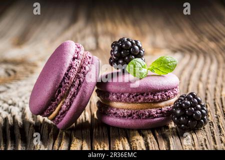 Blackberry macaroons on a wooden table Stock Photo