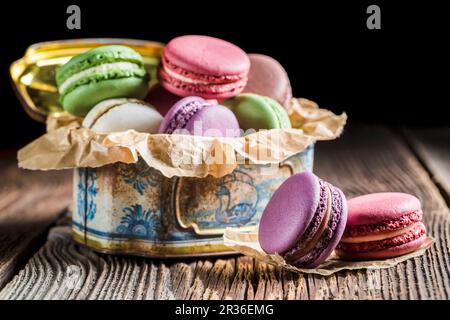 Colourful macaroons in an old metal tin Stock Photo