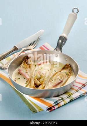 Braised chicory in a white wine sauce Stock Photo