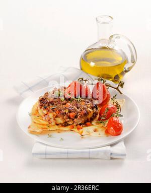 Hamburger on Sardinian bread with braised tomatoes Stock Photo