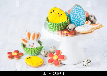 Colourful Easter biscuits and quails egg's on a cake stand Stock Photo