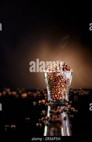 A glass of freshly roasted coffee beans Stock Photo