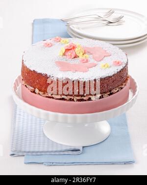 A celebratory almond cake decorated with pink marzipan Stock Photo