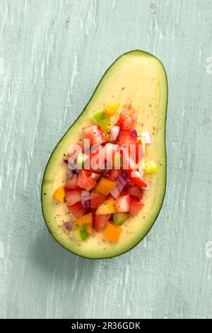 Avocado filled with vegetables Stock Photo