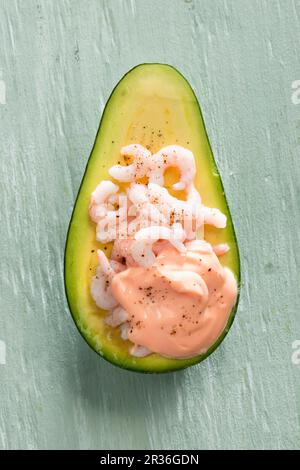 An avocado filled with prawns Stock Photo