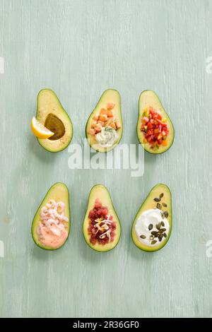 Avocados with various fillings Stock Photo