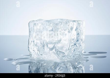 A block of ice on a reflective surface Stock Photo
