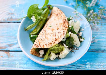 Tortilla with cauliflower, fava beans and avocado Stock Photo